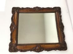 An Edwardian wall mirror with bevelled glass and moulded frame (38cm x 42cm)