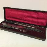 An Edwardian Sheffield three piece horn handled carving set in original fitted case (knife: 38cm)