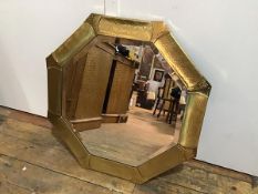 A 1930s brass octagonal wall mirror with panelled border and bevelled glass plate (d.63cm)