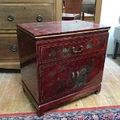 A modern Japanese red lacquered cabinet, with allover tortoiseshell effect ground with bird and