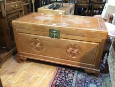 A modern Chinese camphorwood chest with moulded top and front, the hinged top over an unfitted