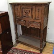Masonic Interest: a 1920s oak side cabinet, with central panelled door carved with Masonic