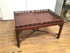 A Chippendale inspired mahogany coffee table with lift out pierced gallery tray top, stand with