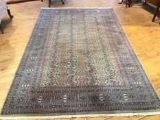 A machine made Belouchi rug, the centre panel with four rows of twenty medallions to each row,