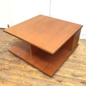 A 1970s teak coffee table with square top above a sectional interior, on castors (40cm x 79cm x