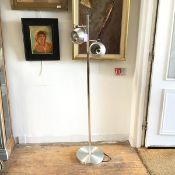 A 1970s brushed stainless steel twin globe spotlamp, on centre square column and circular base (