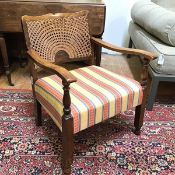 An early 20thc low armchair, with cane back and upholstered seat (68cm x 57cm x 58cm)