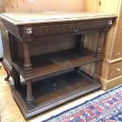 A Victorian oak buffet, with moulded frieze drawer flanked by two lion masks, with two tiers