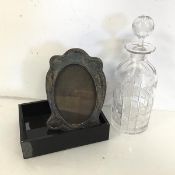 A mixed lot comprising a silver photograph frame (19cm x 13cm), an etched and cut decanter and