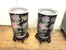 A pair of famille noir style modern cylinder vases, decorated with crysanthemum design, on