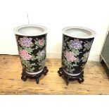 A pair of famille noir style modern cylinder vases, decorated with crysanthemum design, on