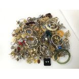 A large assortment of costume jewellery including bangles, bracelets, rings, brooches etc. (a lot)