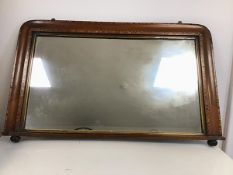 An Edwardian overmantel mirror, the rosewood frame with a speciman wood parquetry border, on bun