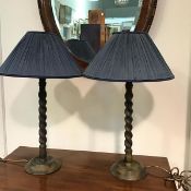 A pair of cast bronze finish spiral column raised on circular moulded bases complete with shades and