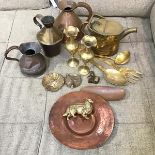 An assortment of brass and copper including flagons, watering can, vases, novelty spoon and fork,