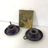 An Edwardian brass doorbell (13cm x 10cm) and a pair of enamel on copper chamber candlesticks (3)