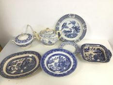 An assortment of 19thc blue and white transfer ware including a Willow pattern bowl, an ashet and