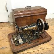 An early 20thc Frister & Rossmann sewing machine, complete with travelling case and with plaque from