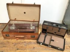 A Finnigans vintage travelling case, with tan leather exterior and the initials S.H.C.L. (21cm x