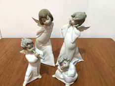 A Lladro Cherub figure playing a Lute and a Lladro Seated Cherub, a Lladro Young Cherub and Two
