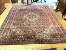 An Axminster Persian style carpet, with centre octagonal medallion enclosed within a multiple