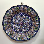A large Turkish mid century wall plaque of scalloped design, the centre panel with stylised