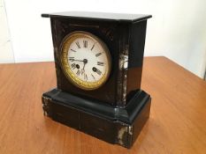 A 19thc black slate and marble mounted mantel clock, with enamelled dial and twin key apertures,