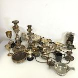 An assortment of Epns including candlesticks, coaster, ladles, forks etc., four trophies, three