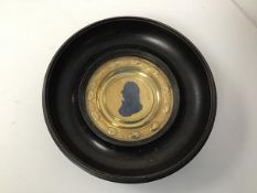 A 19thc. gilt metal Commemorative plaque of Admiral Lord Nelson within a dished ebonised circular