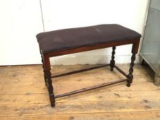 A 1920s/30s footstool on barley twist supports with box stretcher, on ball feet (47cm x 72cm x