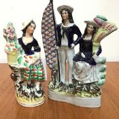 A Staffordshire flatback figure group, The Sailor and His Wife, decorated with polychrome enamels (