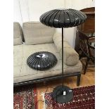 A modern floor lamp with perforated shade in the form of a flattened Chinese lantern, with