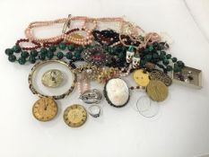 An assortment of costume jewellery including a malachite bead necklace, a coral necklace, a WWI