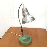 A 1950s desk/table lamp with cast iron green enamelled base, on steel and chromium plated adjustable