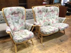 An Ercol light ash sofa, with matching easy chair, both with traditional spar backs and floral