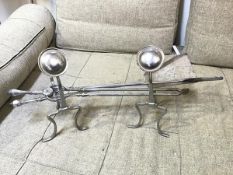 A pair of silvered andirons with circular dished finials, and fire tools including tongs, poker