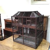 A large decorative Victorian bird cage, the sarcophagus shaped top with coloured glass to corners
