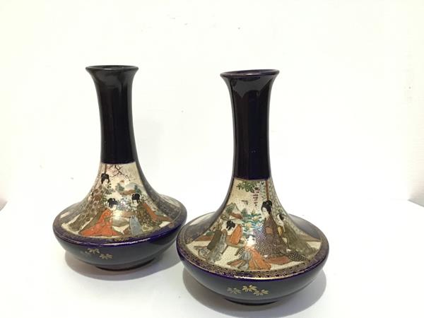 A pair of Japanese Satsuma bottle neck flared vases decorated with figure scenes with blue
