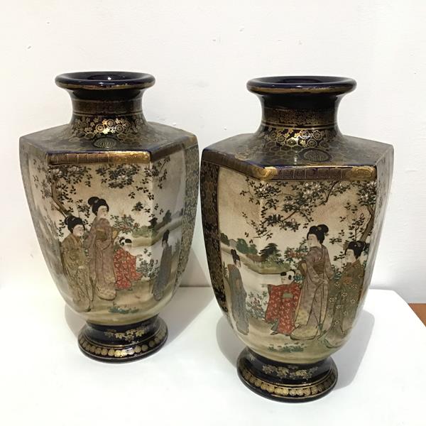 A pair of Japanese Satsuma octagonal baluster tapered vases decorated with landscape and figure