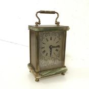 A carriage clock with onyx top and base, with gilt metal mounts, the dial with roman numerals