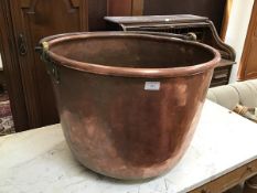 A large copper cauldron with swing handle (41cm to top of rim x d.60cm)