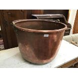 A large copper cauldron with swing handle (41cm to top of rim x d.60cm)