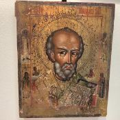 A 19th century Russian icon of St. Nicholas, depicted head and shoulders, carrying a bible, the