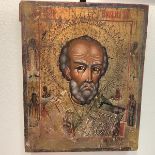 A 19th century Russian icon of St. Nicholas, depicted head and shoulders, carrying a bible, the