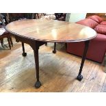 A mid-18th century gateleg dining table, the mahogany oval top with twin drop flaps, raised on