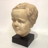 20th Century School, Portrait Bust of a Young Boy, plaster, unsigned, mounted on an ebonised plinth.