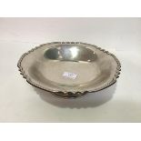 A silver fruit bowl, Walker & Hall, Sheffield 1957, with reeded shaped rim, raised on a stepped