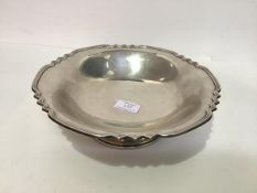 A silver fruit bowl, Walker & Hall, Sheffield 1957, with reeded shaped rim, raised on a stepped