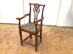A 19th century elm child's high chair, with yoke top rail and pierced splat within outswept arms