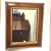 A 19th century rosewood wall mirror, the rectangular plate within a cushion-moulded frame with